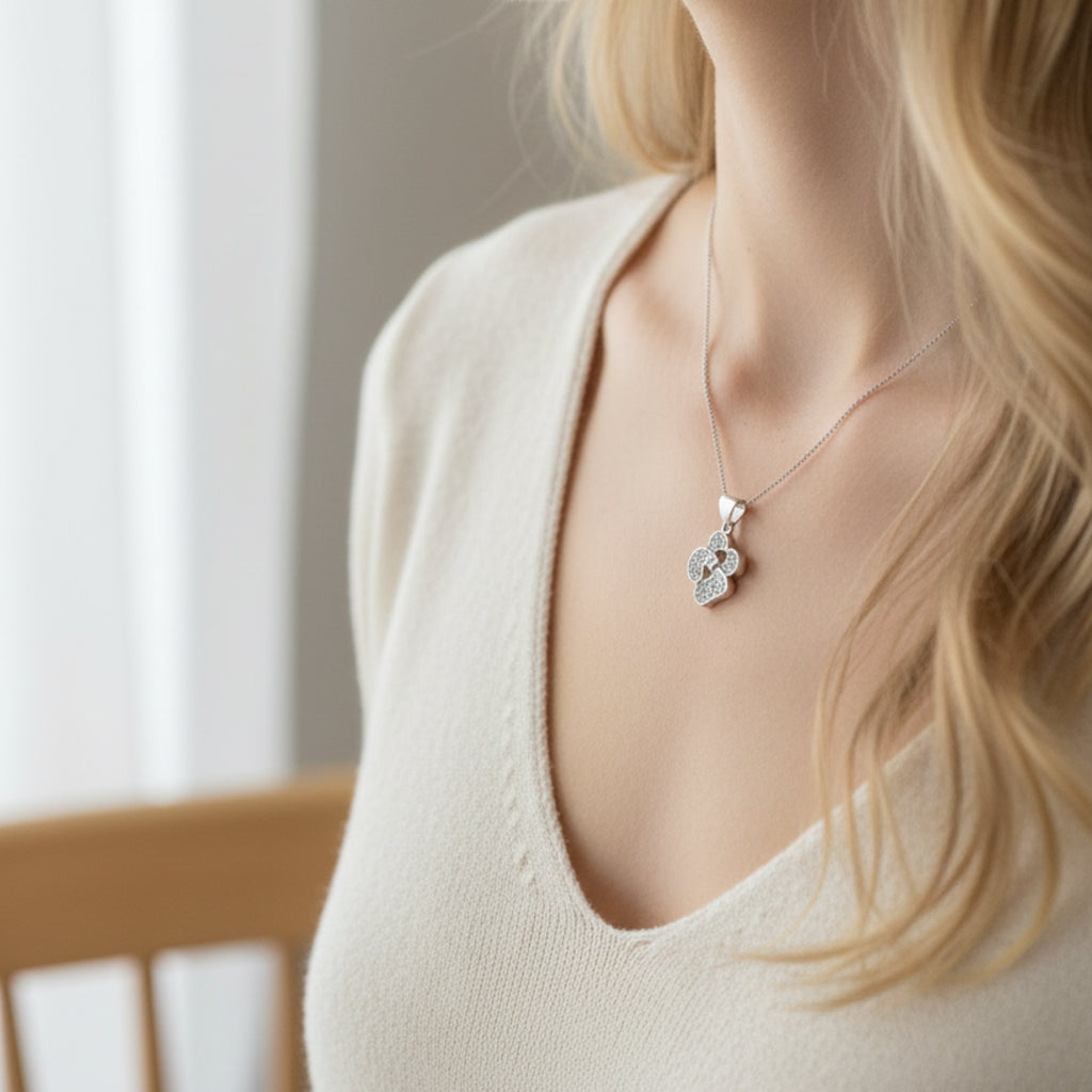 Femme portant le Collier Belle Isa avec pendentif nœud rhodié - Bijou argenté élégant au niveau du décolleté
