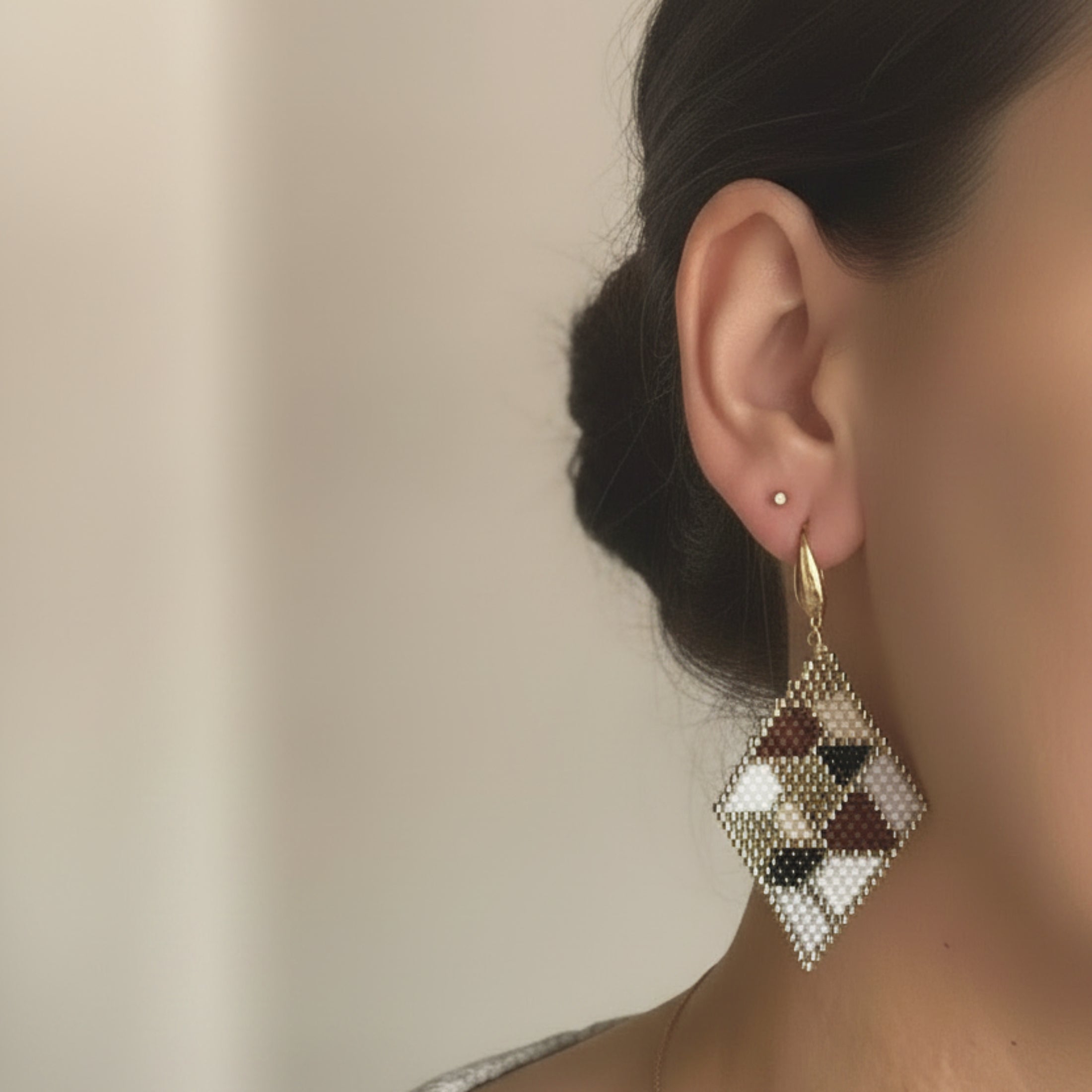 Boucles d'oreilles Paloma ÔParis portées, tissage Miyuki Delica motif géométrique beige rosé et brun doré, longueur 6 cm, finition crochet doré.
